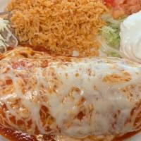Fajiburrito Steak Suizo · Filled with steak, grilled bell peppers, onions, beans, and cheese. Rice, beans, lettuce, to...