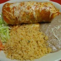 Fajiburrito Texano Suizo · Filled with grilled chicken, steak, shrimp, bell peppers, onions, beans, and cheese. Rice, b...