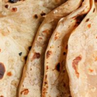 Roti · traditional hand tossed  whole wheat bread freshly bake in a tandoor clay oven