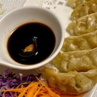 Pot Stickers (6Pcs) · Deep-fried thin pastry shell filled with chicken and mixed vegetables served with homemade s...