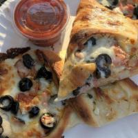 The Sicilian Stromboli · Pepperoni, Virginia ham, black olives, onions, topped with our garlic butter herb sauce and ...