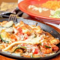 #17. Fajitas Supreme · A combination of steak, chicken, and shrimp with yellow and green squash, onion, tomatoes, t...