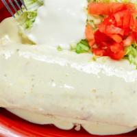 #76. El Grande Burro · A big burrito stuffed with your choice of steak or chicken rice and beans inside with melted...