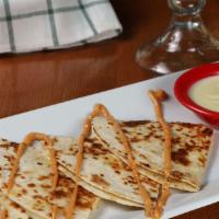 Quesa-Time · A large cut-up cheese quesadilla drizzled with chipotle sauce. Served with a small side of c...