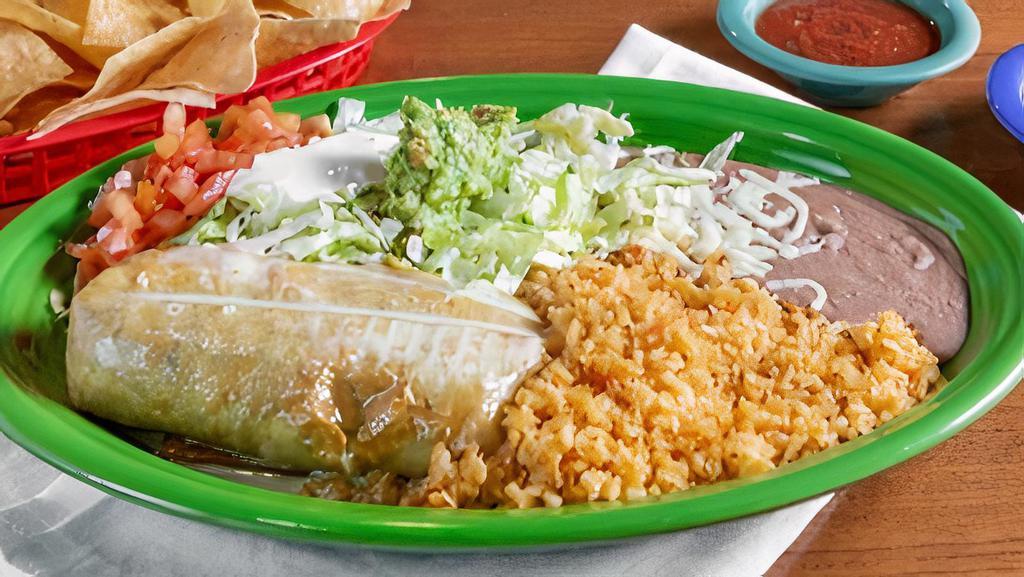 Chimichanga · A large flour tortilla stuffed with your choice of filling, wrapped up, and deep fried. Topped with white cheese dip. Served with guacamole, lettuce, sour cream, rice and beans.