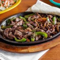 Steak Fajitas · Steak grilled with bell peppers, tomatoes, and onions. Served with rice, beans, guacamole, l...