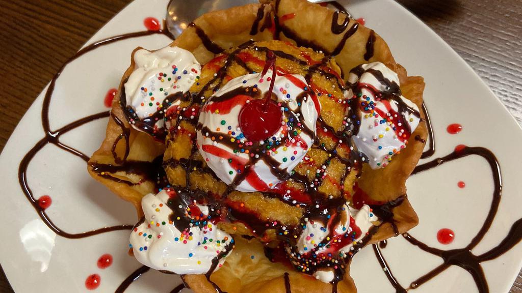 Signature Fried Ice Cream · Vanilla ice cream covered in frosted flakes & slightly deep fried. Served in a crispy tortilla bowl. Topped with whipped cream, sprinkles, & chocolate syrup.  (Made in-house)