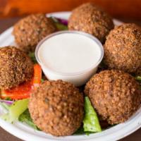 Falafel Appetizer · Vegan. 6 pieces of falafel are served on a bed of house salad. Served with side of tahini sa...