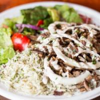 Beef Shawarma Plate · Served with your choice of rice, house salad, topped with raw onions and tahini sauce and gr...