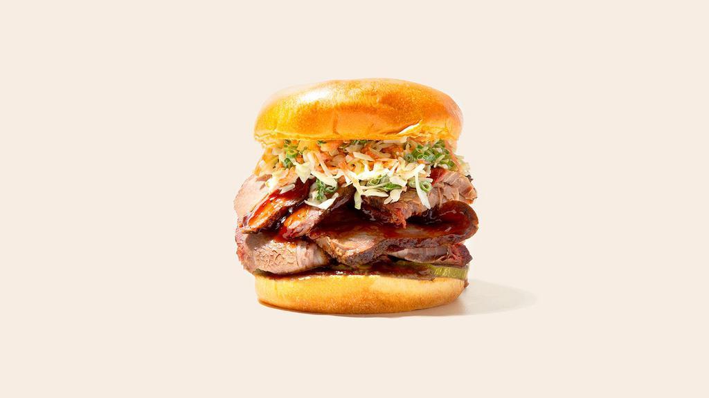Bbq Brisket Sandwich · Smoked beef brisket with coleslaw and bbq sauce on a fluffy bun.