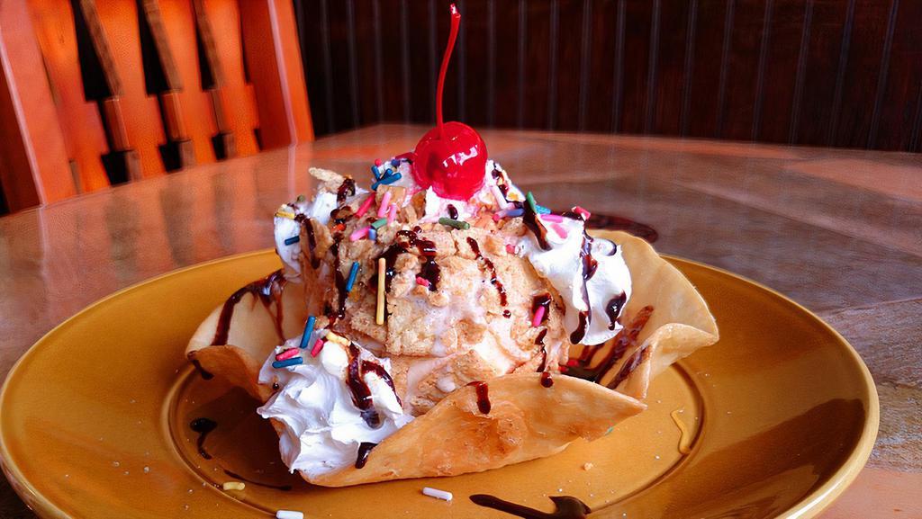 Fried Ice Cream · A Classic! A giant scoop of vanilla ice cream topped with sizzling caramel syrup, sprinkles, whipped cream, chocolate syrup, and a cherry.