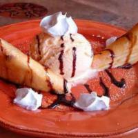 Mexican Cheesecake · Flutes of flour tortillas stuffed with cheesecake filling and topped with honey and cinnamon...