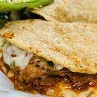 Quesabirria  · Two fresh handmade corn tortillas filled melted mozzarella cheese,  beef birria, cilantro, a...