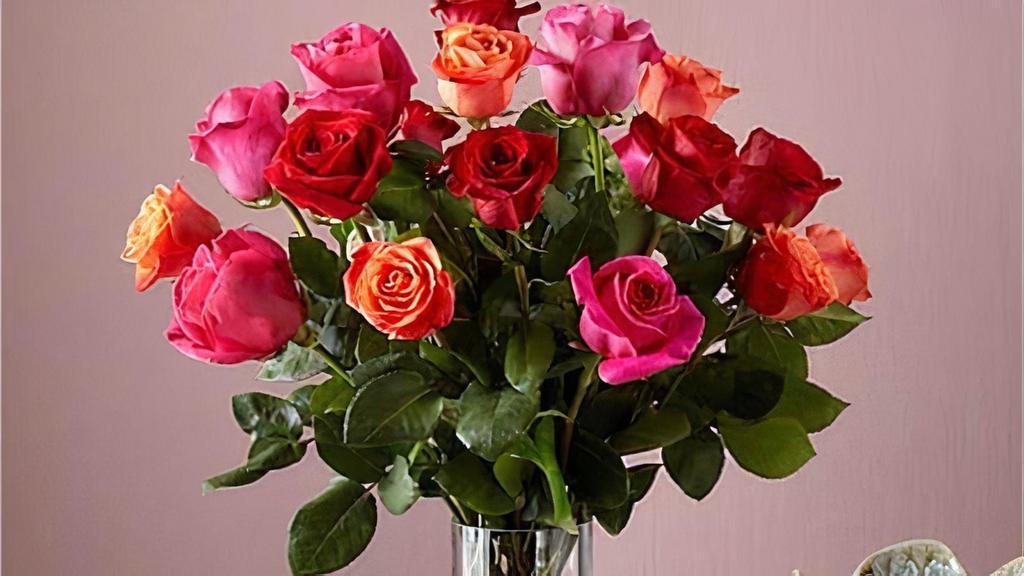 18 Mixed Rose Bouquet · Live happily with the Ever After Mixed Rose Bouquet. This arrangement features 18 roses in three vibrant hues: orange, hot pink, and red. This trifecta will warm any space they're displayed in and any recipient's heart. Vase included. Please Note: The bouquet pictured reflects our original design for this product. While we always try to follow the color palette, we may replace stems to deliver the freshest bouquet possible, and we may sometimes need to use a different vase. Item #V1MD