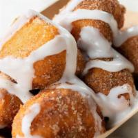 Doughnuggies · Our proprietary donuts holes tossed in cinnamon sugar and drizzled in icing.