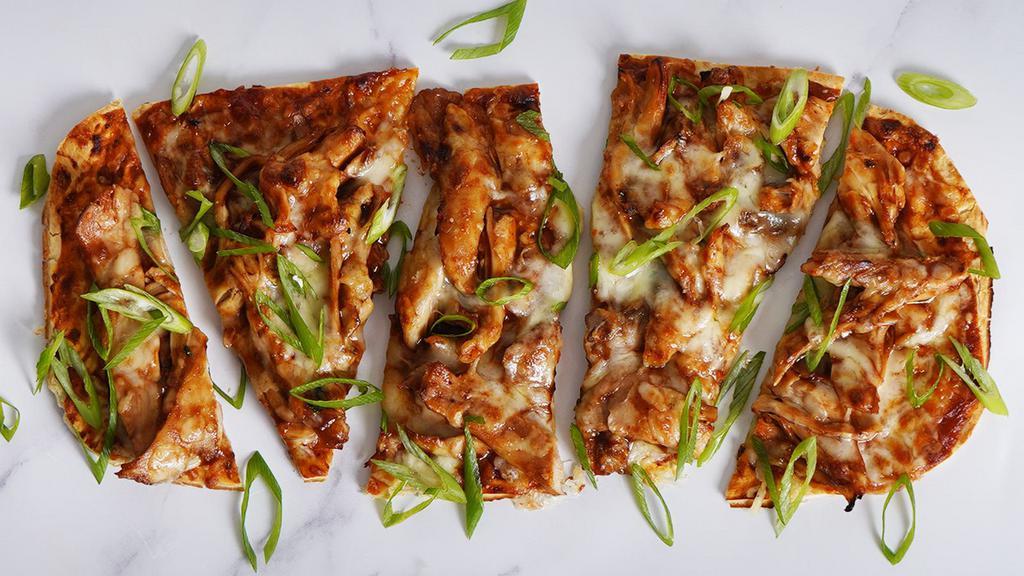 Bbq Chicken · Our classic flatbread brushed with tangy barbecue sauce and loaded with barbecue chicken, mozzarella, and scallions.