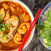 S2 Bun Mam · Vietnamese seafood gumbo: Thick rice noodles, sliced pork, shrimp, squid & catfish filet in ...