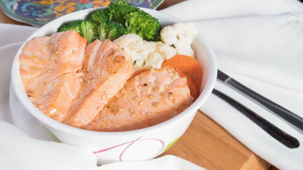 Teriyaki Salmon · Fresh salmon, carrot, zucchini, broccoli, cauliflower and white onion grilled with teriyaki sauce.