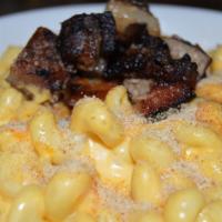 Mac & Cheese · House made with smoked cheddar cheese. Top it off with your choice of brisket or pork belly.