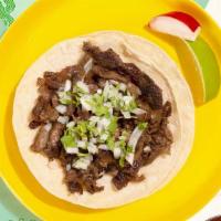 Carne Asada Taco · Marinated steak topped with cilantro and chopped onion on a soft corn tortilla.