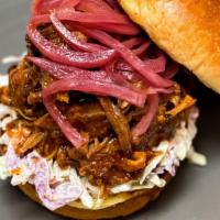 Carolina-Style Pulled Pork Sandwich · Beeler's bone-in pork shoulder is marinated in our Smokeheads Signature Dry Rub and steadily...