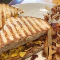 The New Yorker · Scrambled eggs, bacon and cheddar cheese grilled on panini bread. Served. with hash browns