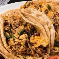 Breakfast Tacos · Eggs scrambled with chorizo, jalapeños and onions, stuffed in three corn tortillas accented ...