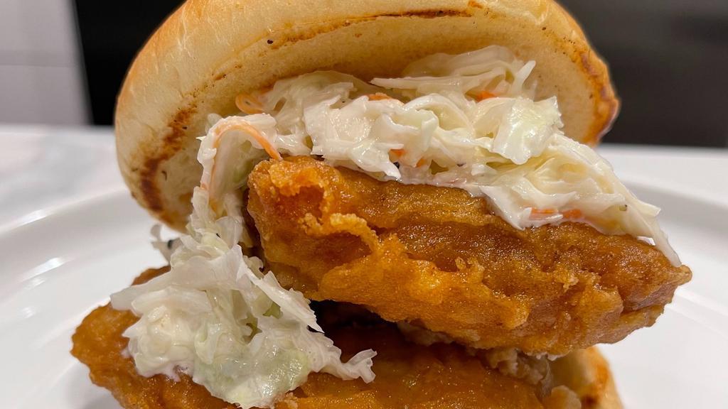 Fish 'Wich · Beer battered atlantic cod, smothered in tartar sauce and topped with our house slaw. Served on a soft brioche bun.