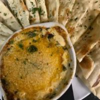 Artichoke Dip · Cream cheese, mozzarella, cheddar, spinach, roasted red peppers, red onions and marinated ar...