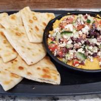 Mediterranean Dip · Roasted red pepper hummus topped with diced tomato, cucumber, feta, olives, served with gril...