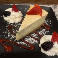 Home-Made Ny Cheesecake · Topped with a fresh berry compote and whipped cream.