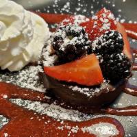 Flourless Chocolate Cake · Raspberry sauce, fresh berries and whipped cream.