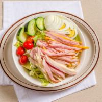 Chef'S Salad · Crisp lettuce and julienne of ham, cheese, tomato and turkey with hard-boiled egg.