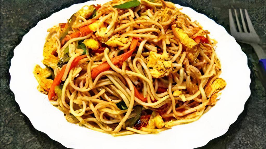 Egg Chowmein · Boiled noodles, deep-fried boiled egg, soy sauce, chowmein Masala, chopped red onions, cilantro, and tomato on top