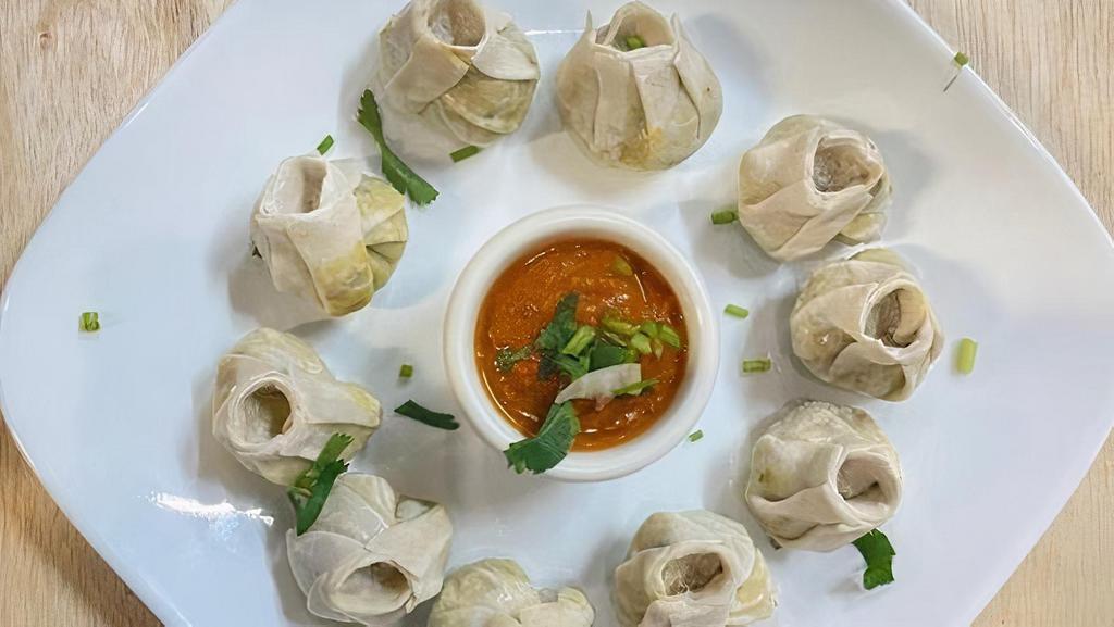 Veg Momo (Steam) · (Mixing and grinding of cabbage, carrot, onion, Ajino moto, Century MOMO masala, deep fry chopped ginger-garlic and chopped onions wrapped in dumpling wrapper)