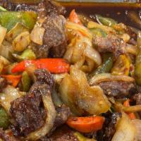 Mongolian Beef · Served with white rice. Sliced beef stir fried w. Onion green onions and vegetables.