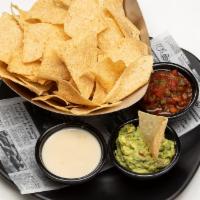 Chips Trio · Tortilla chips with guacamole, queso, and salsa.