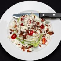 Classic Wedge · Iceberg wedge, bacon bits, blue cheese crumbles and grape tomatoes with our house-made ranch...