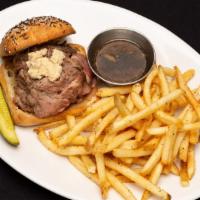 Beef On Weck · Thin sliced prime rib served medium, topped with horseradish on a kimmelweck roll. Served wi...