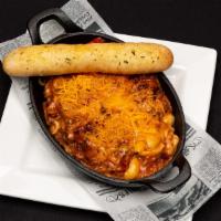 Mac Daddy Mac · Pork BBQ, cheddar cheese, roasted red pepper and cherrywood smoked bacon. Served with a brea...