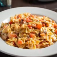 Farfalle Pollo · Grilled chicken, sun-dried tomato, mushroom, plum tomato, basil, pecorino cream sauce, shred...