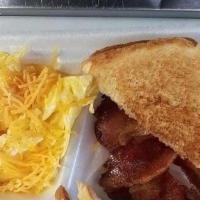Bacon Breakfast · Served with two eggs, grits, and Toast