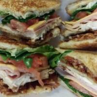 Turkey Club · Turkey, lettuce, tomato, bacon, cheese and mayo, chips and pickle.