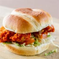 Buffalo Chicken Sandwich · Crispy chicken breast, tossed in buffalo sauce, served with lettuce, tomato, and ranch on a ...
