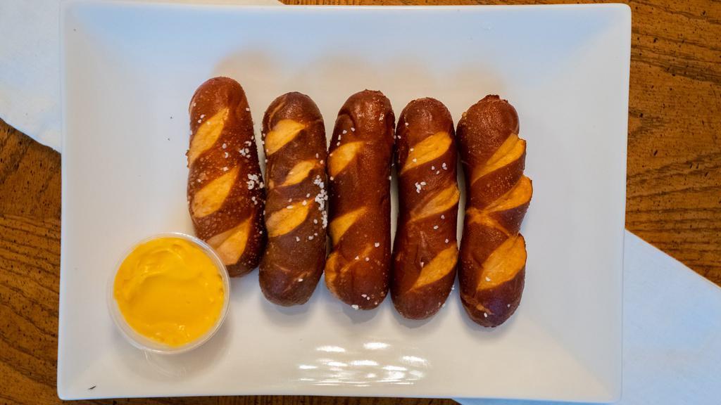 Pretzel Sticks · Warm pretzel sticks sprinkled with salt and served with cheddar cheese.