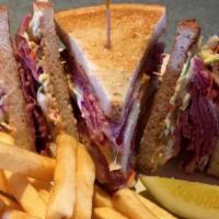 Dinty Moore · A classic triple decker. Corned beef, swiss cheese, cole slaw and thousand island dressing o...