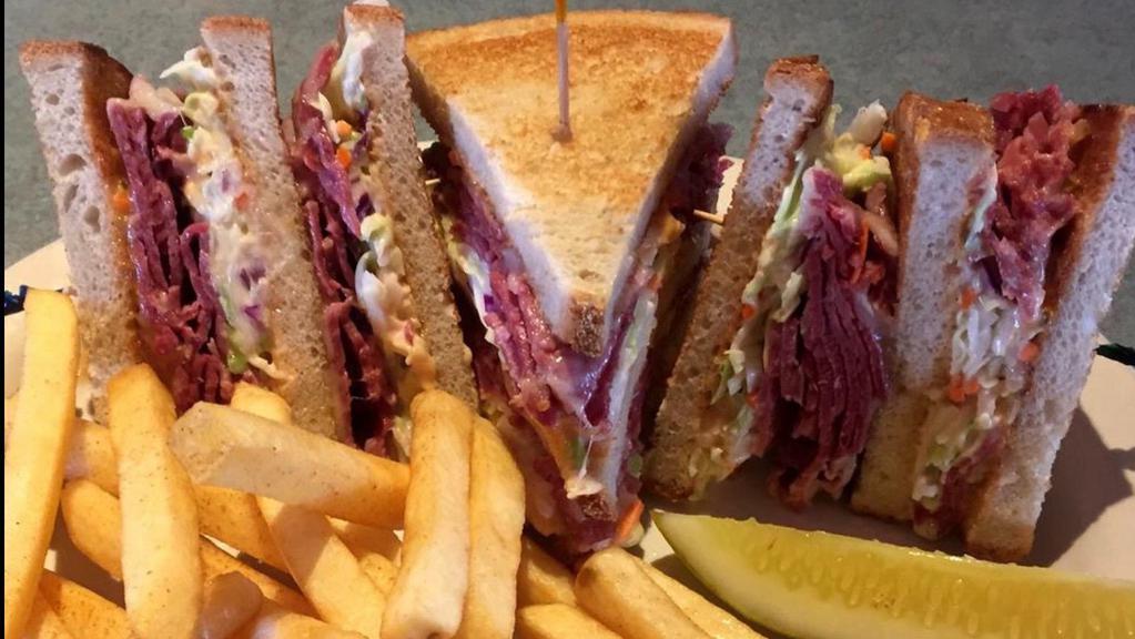Dinty Moore · A classic triple decker. Corned beef, swiss cheese, cole slaw and thousand island dressing on toasted rye.