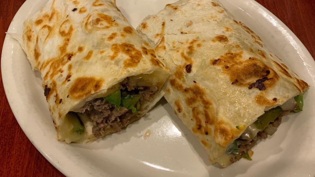 Philly Cheese Steak Wrap · Shaved steak with grilled onions, peppers and swiss cheese.