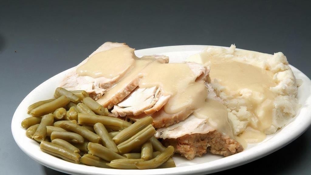 Fresh Oven Roasted Turkey · Slow roasted, hand carved turkey breast over stuffing topped with gravy and served with mashed potatoes and vegetable.