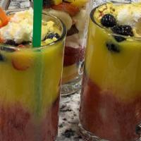 Tropical Cocktail · Chunks of pineapples, mangos, strawberries, bananas, kiwis, blueberries, strawberry juice, m...